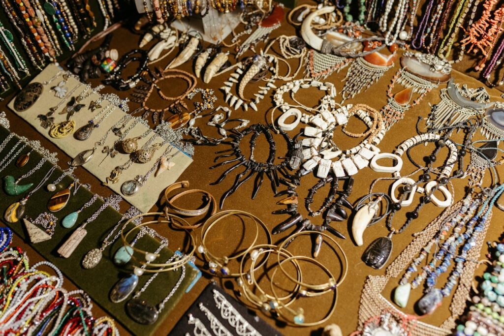 A vibrant display of handcrafted jewelry including necklaces, bracelets, and earrings at a market stall.