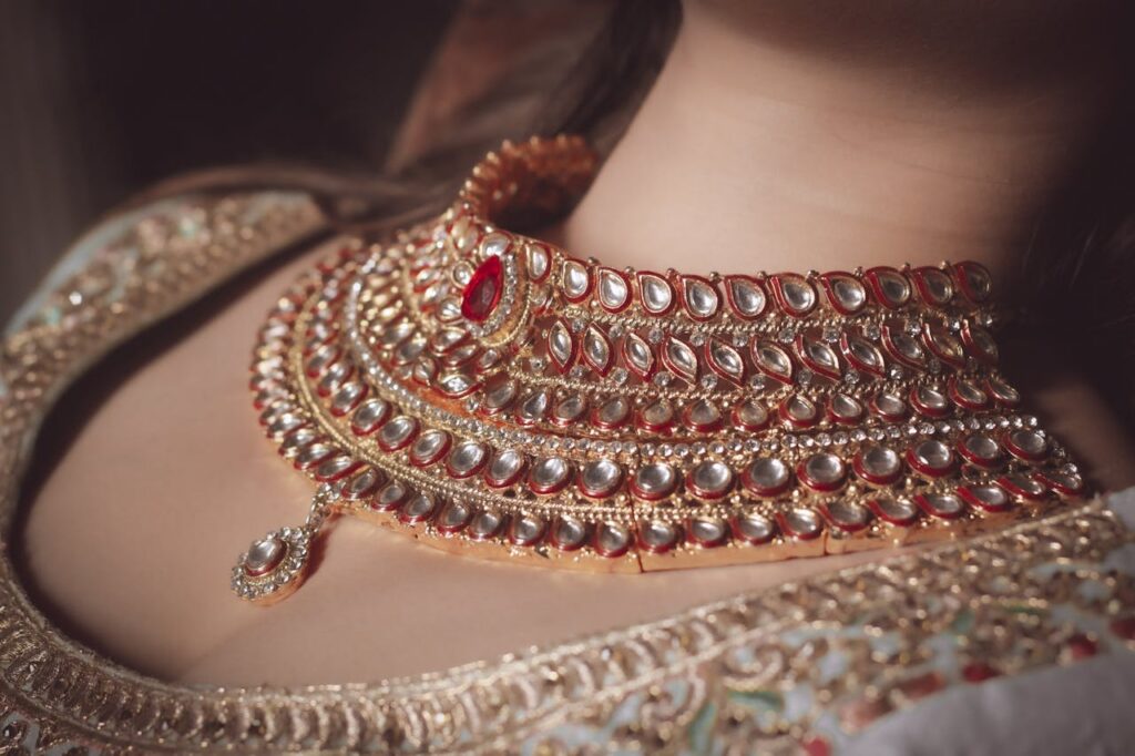 Close-up of intricate Indian bridal necklace showcasing gold and Kundan craftsmanship.
